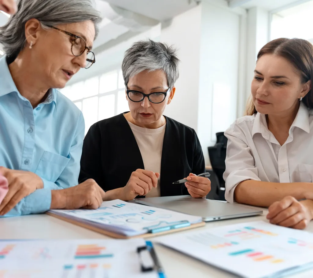 Three colleagues reviewing a financial analysis together