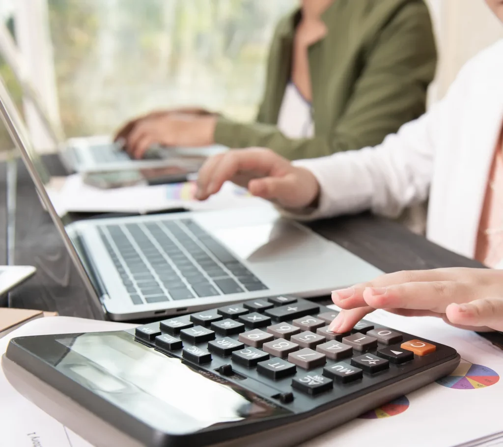 Working through figures on a calculator and laptop