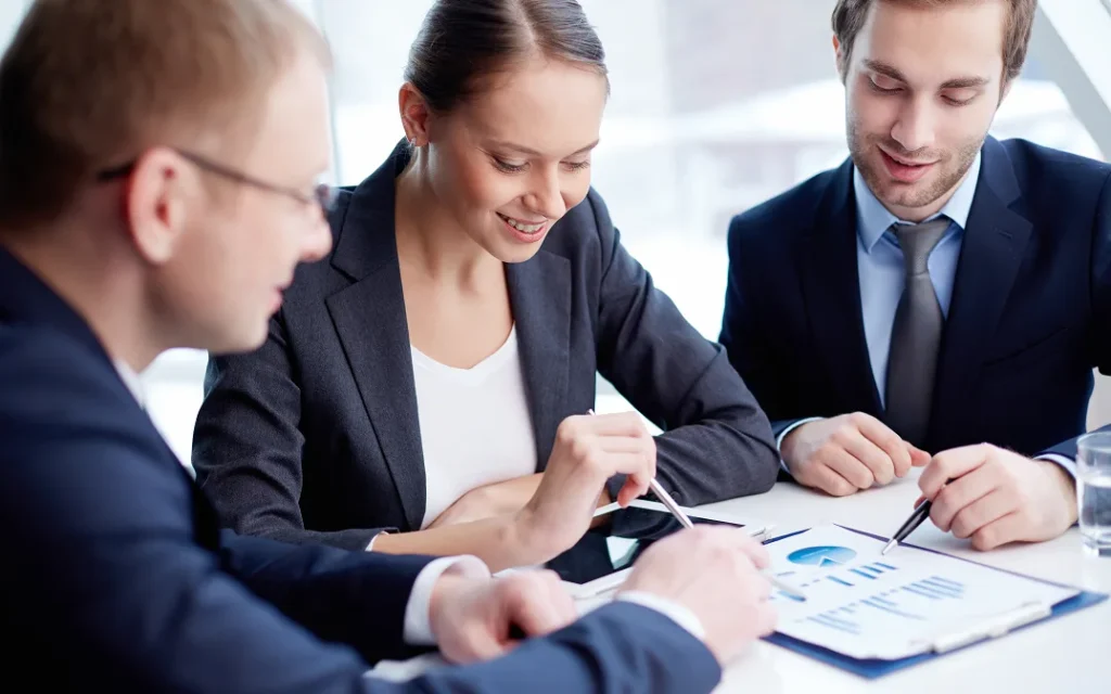 Three business owners reviewing their financials together