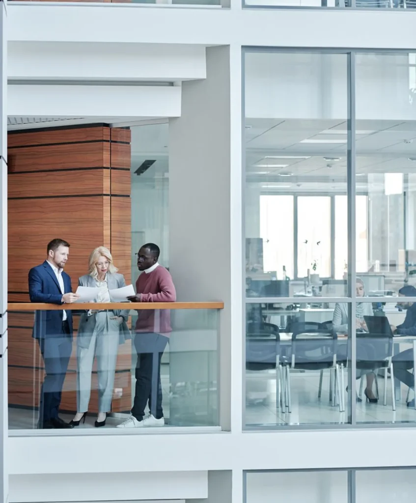 Team members reviewing reports in an office stairwell