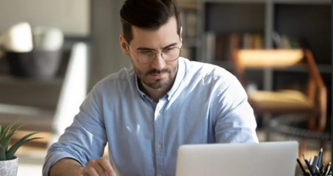 Business owner reviewing his finances on a laptop