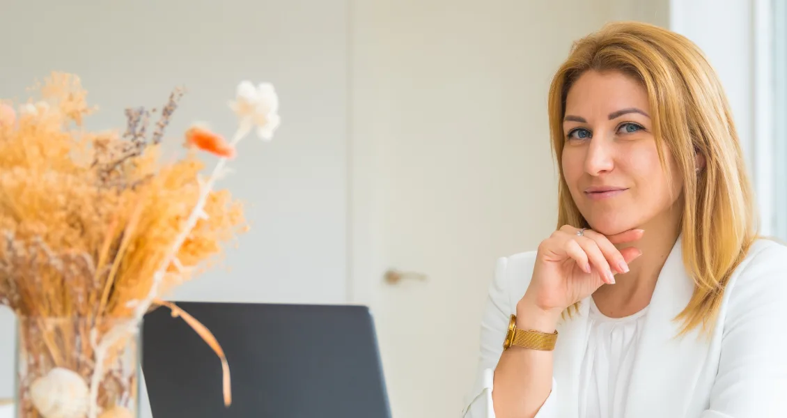 Business owner standing with her laptop